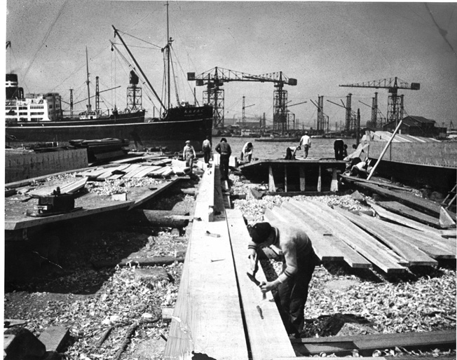 Japanese shipwrights work to construct a vessel in the bustling port city of Kobe. The Japanese effort to replace combat losses and keep pace with U.S. production of warships proved futile as the war dragged on.