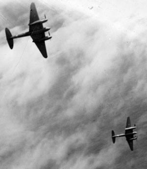 Flying off the coast of Australia, a pair of de Havilland Mosquitos make practice bombing runs during training exercises. The Mosquito served in all theaters of World War II and was admired by its Axis enemies.