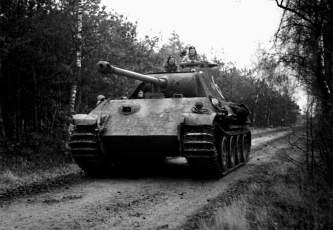 Shown rolling along a dirt road in northwest Europe on November 29, 1944, a captured German Panther tank is in use by the British 4th Coldstream Guards, 6th Guards tank brigade.