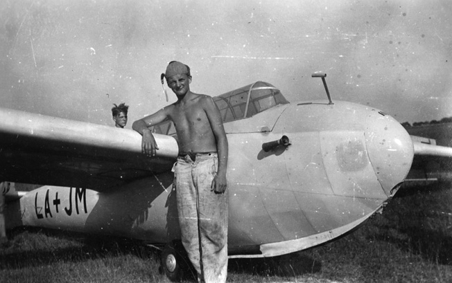 Dulias poses in front of a two-seater Olimpia Kranich soaring plane after a solo flight in the summer of 1944.