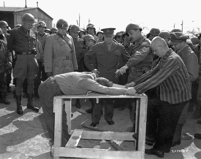 Eisenhower, again with Patton (left) and Bradley, listens as a translator explains some of the torture techniques used at the Ohrdruf concentration camp.