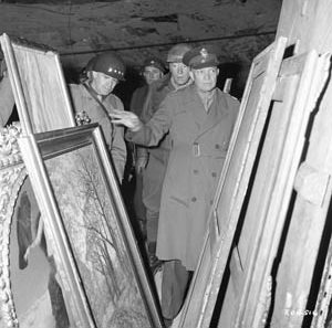 General Omar Bradley (far left), Patton, and Dwight D. Eisenhower examine precious paintings in the Merkers salt mines Patton's assistant, Charles Codman, can be seen in the background.