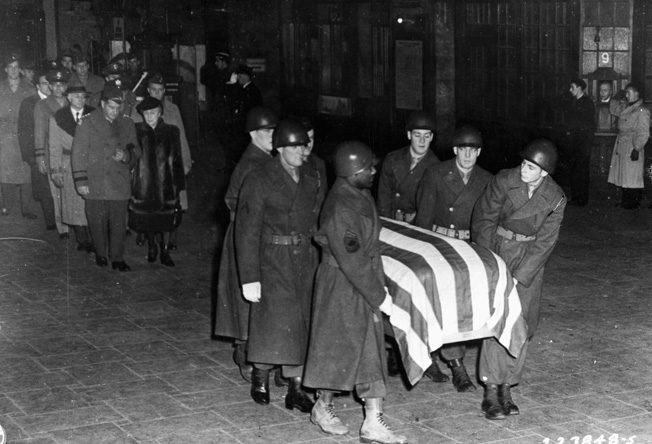 General Patton's wife, Beatrice, follows his casket through the train station in Luxembourg City en route to the nearby cemetery in Hamm.