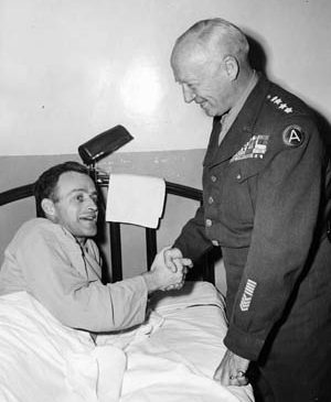 General Patton visits his son-in-law, Lieutenant Colonel John Waters, while the latter recuperates in Walter Reed U.S. Army Hospital in Washington, D.C. Waters had been held in a German prison camp for three years. Patton was reported to have attempted a rescue operation at one time.