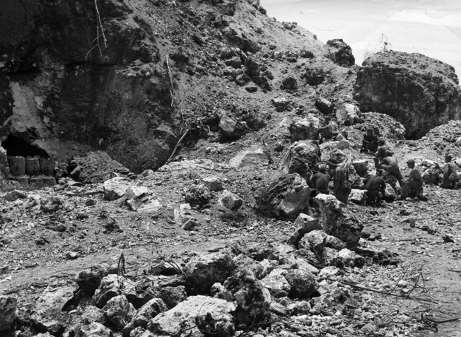 Marines blast away at Japanese defenders hidden in their caves. 
