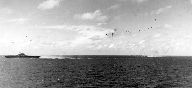 A photographer aboard the USS Lexington took this photo of 20mm and 40mm antiaircraft fire striking home against an attacking Japanese plane. The aircraft had initiated a run against an American carrier of Task Force 58.3 in the foreground, but it can be seen trailing thick, black smoke in the distance.