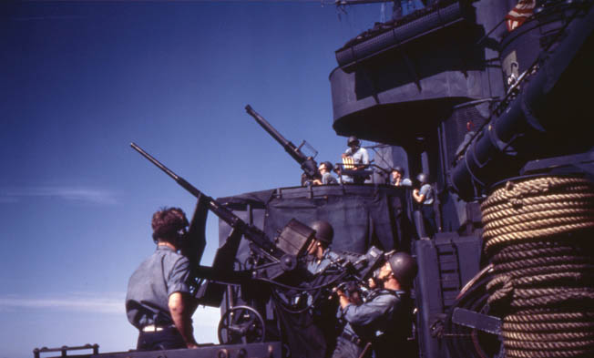 The 20mm and 40mm antiaircraft guns aboard an American destroyer, possibly the USS<em> Halford</em>, swing into action off the coast of Saipan.