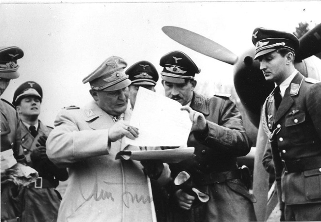 Reichsmarshal Hermann Göring, chief of the Luftwaffe, stands at left while conferring with Adolf Galland during an inspection of Galland’s former fighter command in 1941.