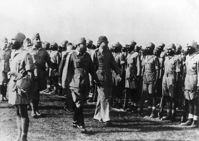 INDIAN NATIONAL ARMY, 1944. Indian nationalist leader Subhash Chandra Bose reviewing soldiers of the Indian National Army in 1944.