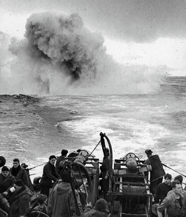 A plume of water shoots skyward as a German U-boat is struck by a barrage of depth charges and "Hedgehog" bombs.