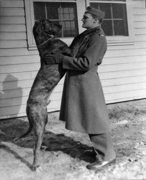 With his Great Dane, Lancelot, ROTC Cadet John Hanlon poses in 1939, during his days on the campus of the University of New Hampshire.