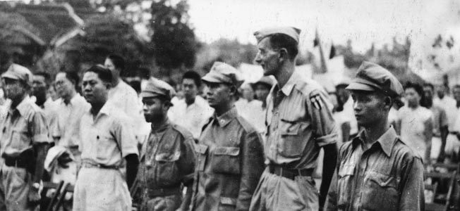 ABOVE: Several still wearing their distinctive helmets, a group of British soldiers taken prisoner following a defeat at the hands of the German Afrika Korps marches toward captivity. RIGHT: General Frank Messervy receives the Legion of Merit from American General Thomas Terry, commander of U.S. forces in the China-Burma-India Theater. Messervy served heroically in the CBI following his North African tenure.