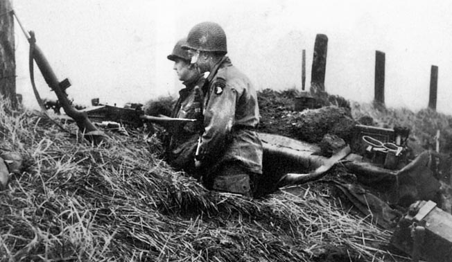 Two Easy Company paratroopers patrol the dikes of Holland. Malarkey pulled British tankers out of a stricken tank and fended off a German tank with mortar rounds while defending “Hell’s Highway.”
