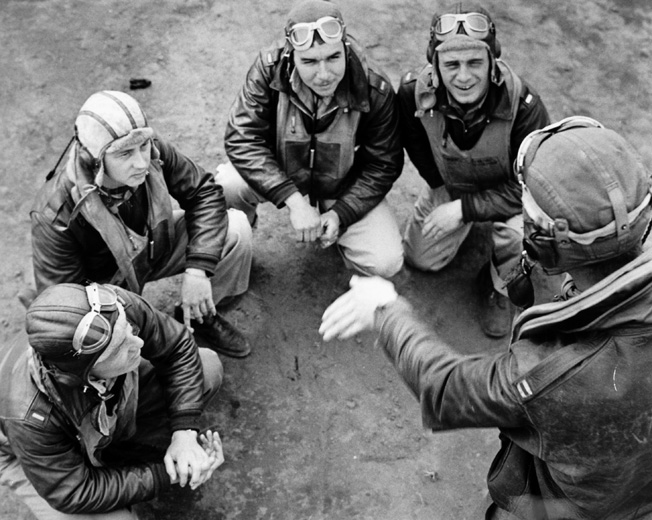 A group of Flying Tigers discusses an upcoming mission. Recognizing their P-40s could not outmaneuver the Japanese fighters, Chennault instructed his flyers to use unorthodox hit-and-run tactics. "Use your speed and diving power to make a pass, shoot, and break away," he told his men.