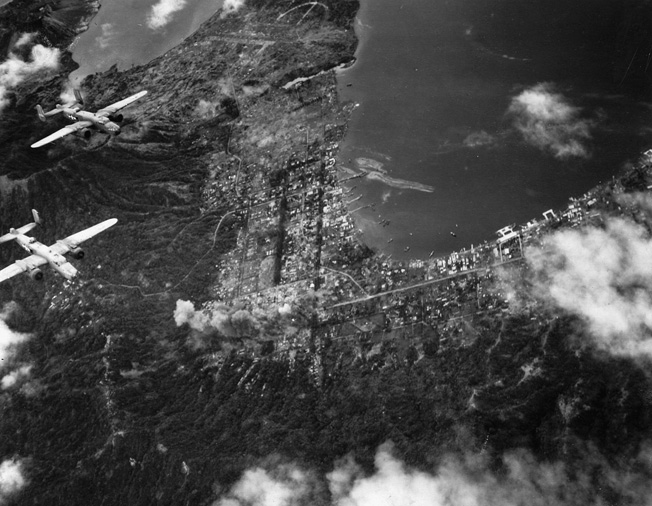 U.S. B-25 Mitchell bombers of the 13th Air Force wing their way above the Japanese bastion at Rabaul in March 1944. The major Japanese supply base and staging area was repeatedly bombed during the American offensive in the South Pacific.