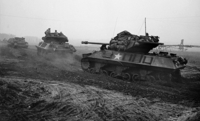 During the opening hours of Operation Veritable, Achilles tank destroyers of the 15th Scottish Division advance toward the Reichswald on February 8, 1945. The main armament of the Achilles was a 17-pounder gun mounted in an open turret.