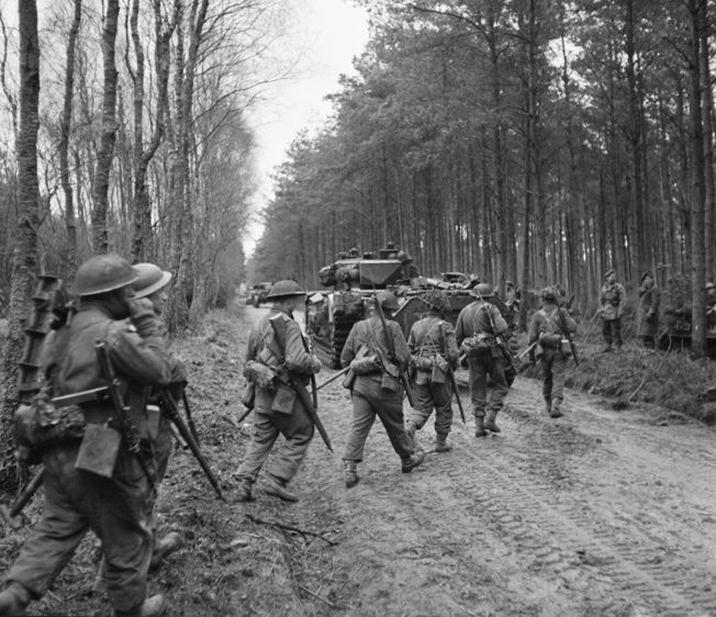 On February 10, 1945, British troops of the 2nd Seaforth Highlanders advance into the Reichs- wald during operations intended to breach German defensive positions and reach the Ruhr, the industrial heart of Germany. Bitter German resistance upset the British timetable and delayed the advance envisioned by British Field Marshal Bernard Montgomery. 