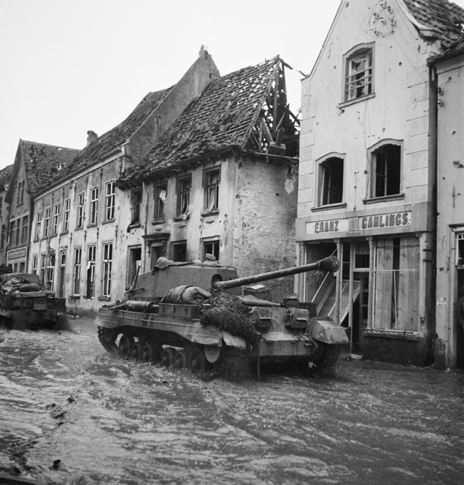 Photographed in the flooded streets of the German town of Kranenburg on February 11, 1945, these British Archer tank destroyers are attempting to reach the front. German defenders opened the gates of numerous dams and flooded extensive areas to slow British progress during Operation Veritable.
