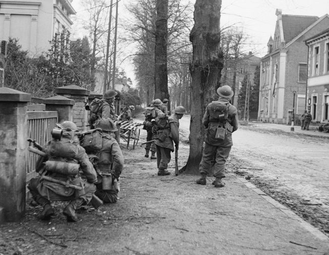 Clearing German snipers and rearguard positions was hazardous duty for these men of the British 2nd Gordon Highlanders advancing through Cleve on February 11, 1945. 