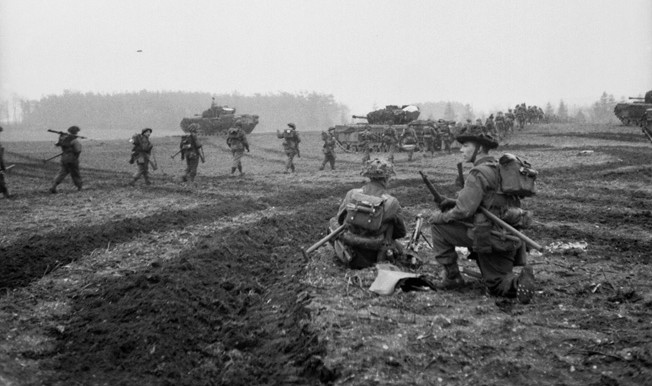 British Churchill tanks support the advance of infantrymen of the 2nd Argyll and Sutherland Highlanders on February 8, 1945. The British advance into the Reichswald was agonizingly slow, and casualties were heavy as the effort to reach the Ruhr bogged down against heavy German resistance.