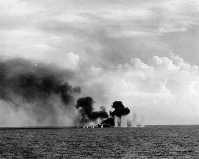 Heavy-caliber shells from Japanese ships bracket the escort carrier USS Gambier Bay during the battle off Samar. Already hit and on fire, the little escort carrier eventually rolled over and sank. The escort carriers were so thinly armored that some Japanese shells passed through one side of their hulls and out the other without detonating.