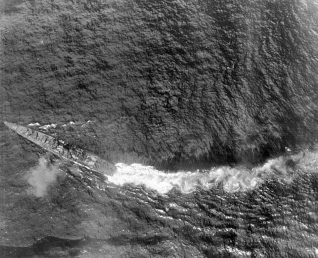 After sustaining torpedo damage during the battle off Samar on October 25, 1944, the Japanese cruiser Chikuma maneuvers violently to avoid more damage. The aggressive attacks of the American destroyers and destroyer escorts helped convince the Japanese that they were facing a much more powerful force. 