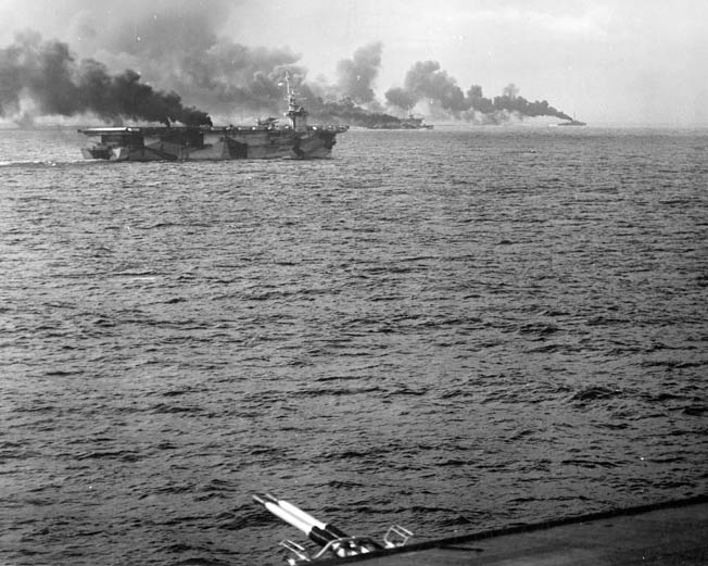 During the opening minutes of the Battle off Samar, the escort carrier USS Gambier Bay and others make smoke to disrupt the aim of Japanese gunners aboard the heavy cruisers and battleships that were poised to wreak havoc with the American troops and transports at Leyte. 