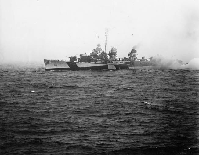 The destroyer USS Heermann brews up a smokescreen off Samar and fights to defend the escort carriers of Taffy 3. Heermann was one of several destroyers and destroyer escorts that crews sailed into an unequal fight with heavy Japanese ships. Heermann survived the ordeal. 