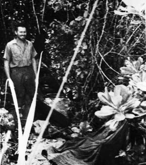 One of the Australian raiders hides the small, two-man canoe he and a comrade paddled to an island near Singapore harbor. 