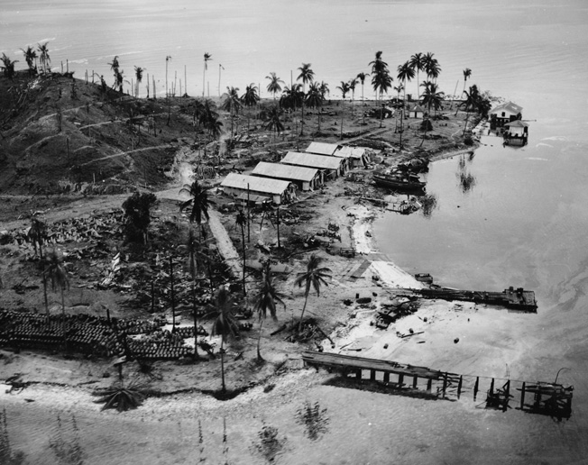 Photographed on August 8, 1942, the day after the U.S. landings in the Solomons commenced, Japanese installations on the island of Tanambogo lie in ruins.