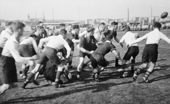 British prisoners of war engage in a game of rugby at Stalag XXID. Prisoners on both sides were often allowed to organize sports teams during the war, and the competition was spirited. 