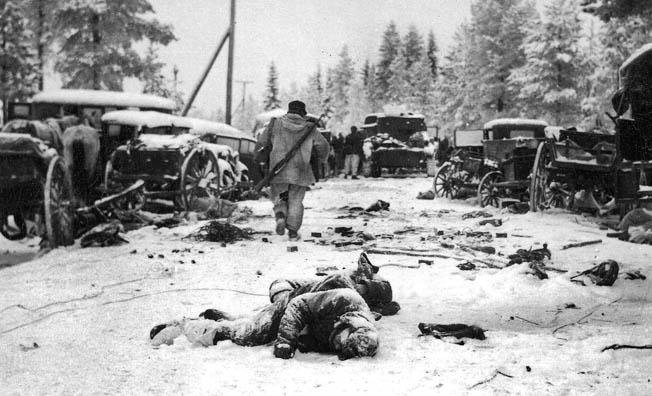 The human wreckage and destroyed equipment of a Soviet column lie abandoned after a Finnish attack has utterly destroyed it.