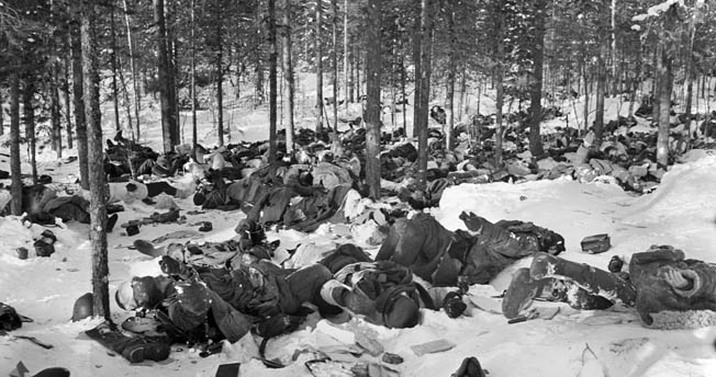 Dead Red Army soldiers lie in heaps after a Finnish attack on their position. The Finns themselves were shocked by the massive Russian casualities they encountered after the battle. 