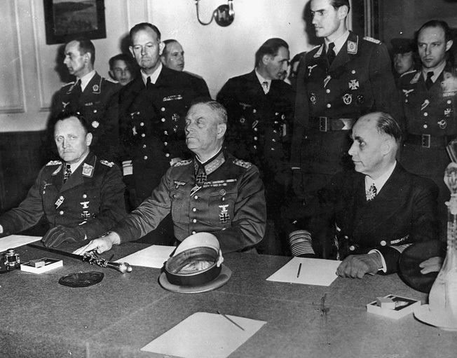 Col. Gen. P.F. Stampf and Field Marshal Wilhelm Keitel sign surrender papers at Russian headquarters in Berlin.