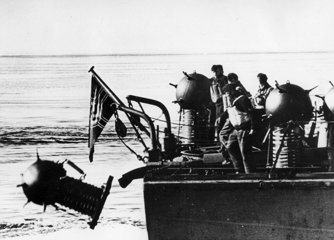 In an attempt to prevent the Soviet Navy from reaching the Baltic Sea, German sailors push floating mines from the stern of their ship into the Gulf of Finland.