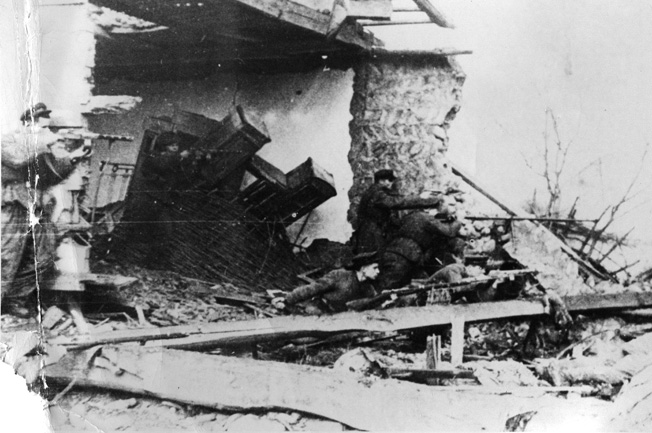 Red Army soldiers take cover behind a mound of debris during their pursuit of retreating German troops after liberating the Taman Peninsula. The victory on the Taman Peninsula was a costly affair for the Soviets during the autumn of 1943.