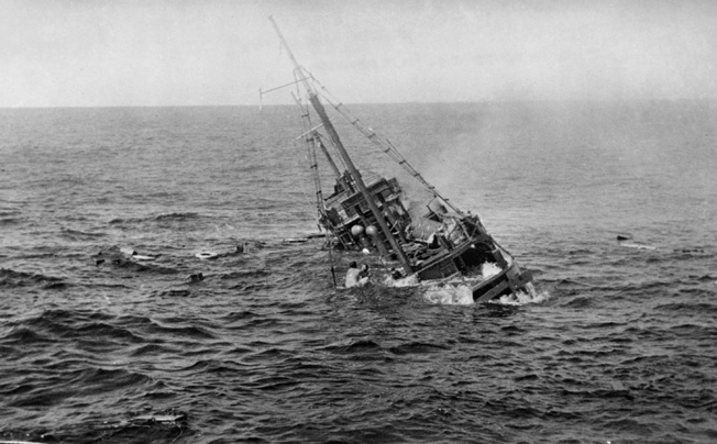 Panicked Japanese sailors cling to the rigging of the freighter Chiyo Maru as it settles beneath the waves. The USS Tambor had engaged the merchant ship with its deck gun in the South China Sea.