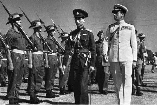 The exiled Thai King Ananda Mahidol reviews Australian troops beside Lord Louis Mountbatten, Allied commander in the China-Burma-India Theater, on January 19, 1946. Postwar cooperation between Thailand and the Allies relegated the earlier Thai flirtation with the Japanese to the dust bin of history.