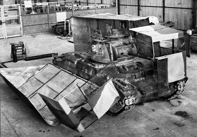 Located at Helwan, Egypt, the Middle East Command Camouflage Development and Training Center was a think tank and laboratory for the deception efforts of A Force. Taken in 1941, this photo shows a British tank with its sunshield split during vehicle servicing on the workshop floor.