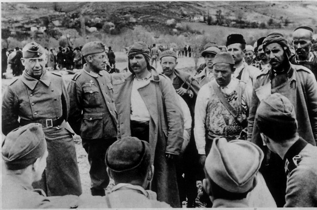 Often fickle with their loyalty, Albanian partisans meet with German officers in the rugged, mountainous country that proved as inhospitable to foreign influence as the partisans themselves. 