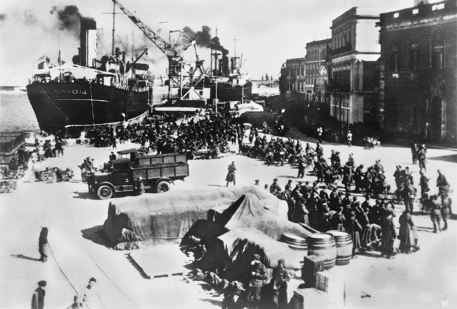 Italian soldiers and equipment are unloaded from transport ships at the port of Durazzo, Albania, in 1939. The conquest of Albania by the Italians gave rise to the partisan movement that proved problematic not only for the Axis, but also for the British.