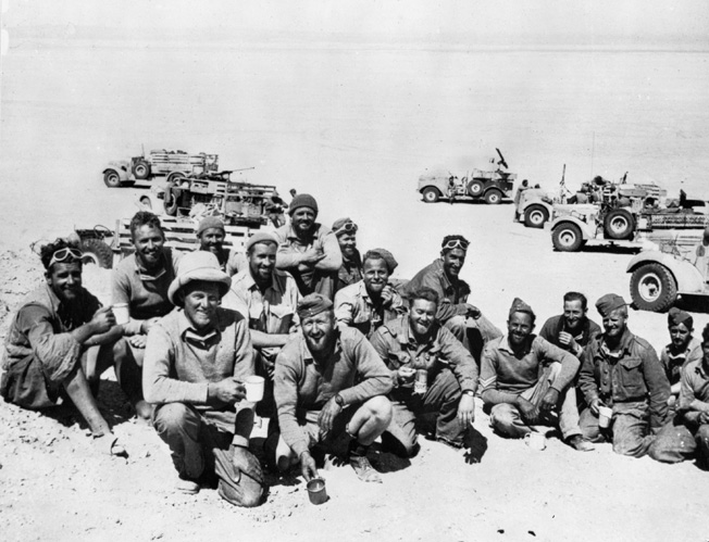 Following a successful foray behind enemy lines in the North African desert, members of the Long Range Desert Group pose for a photograph in March 1941.