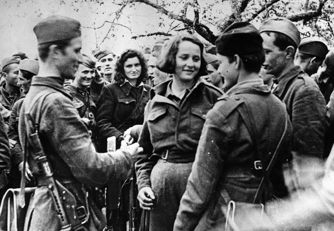 Several members of Tito's communist partisans are seen in this August 1944 photo. As many as 30 percent of Tito's fighters were women who wore the same uniform and fired the same weapons as the men.