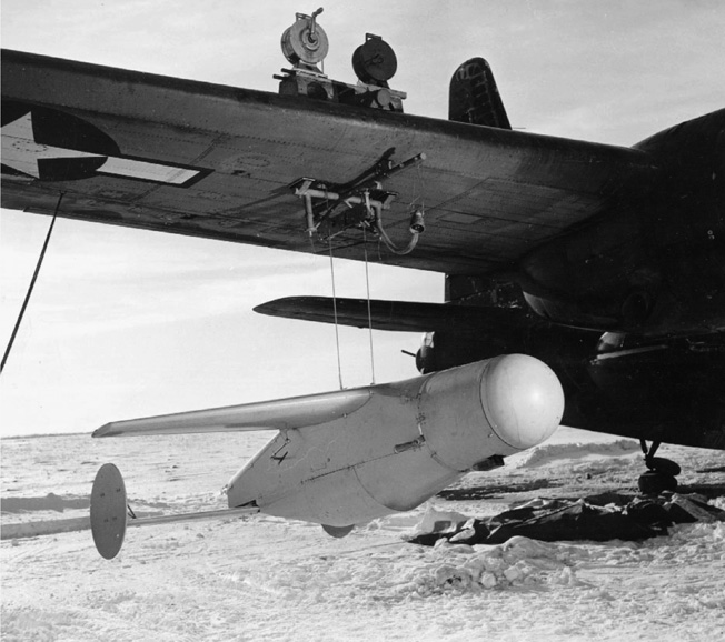 A BAT missile is lifted into position on a PB4Y aircraft prior to a mission in the Pacific.