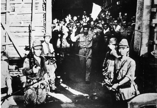 Defenders emerge from a Corregidor tunnel with their hands up and surrender to victorious Japanese troops. Many years of captivity awaited the Americans and Filipinos, if they survived at all.