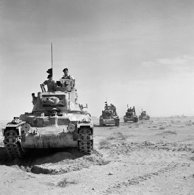 On November 18, 1940, the day before the battle at Bir el Gubi, British Matilda tanks roll forward during the opening phase of Operation Crusader. The British armor spearheaded an effort to reach the Australian garrison besieged at the Libyan port of Tobruk.