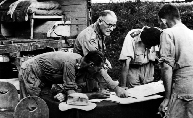 Major General D.T. Cowen (center) of the 17th Indian Division briefs subordinates on the plans for coming engagement.