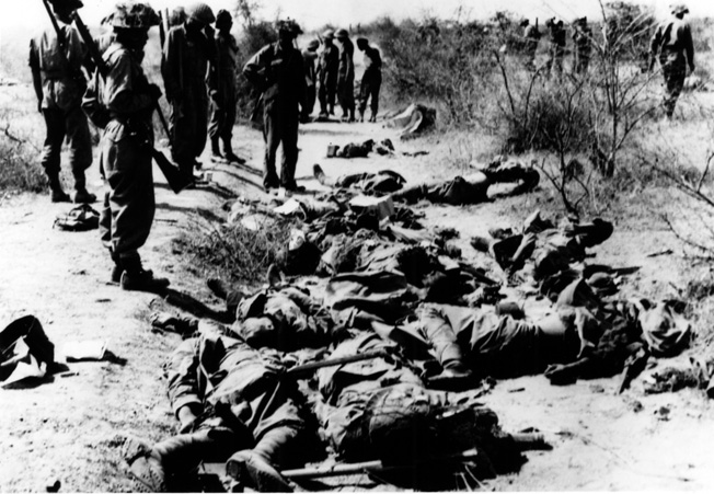 The cost of an unsuccessful counterattack at Meiktila is apparent as British soldiers view scores of dead enemy troops.
