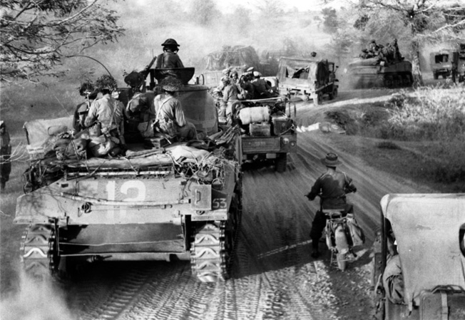 Advancing one the road between Myaungyu on the Irrawaddy River and Meiktila, Sherman tanks and vehicles of the British 62nd Motorized Brigade keep a strenuous pace, March 1945.