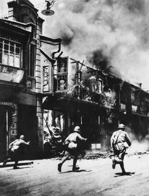 Japanese troops rampage through a burning section of Shanghai, China, January 10, 1937. After the city was occupied, the Bridge House Hotel, converted into a prison by the dreaded Kempeitai secret police, became a place of torture and death.